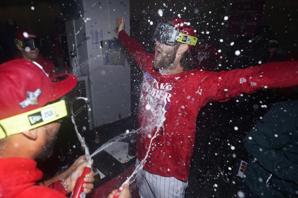 Philadelphia Phillies' Bryce Harper celebrates after winning a baseball game against the Pittsburgh Pirates to clinch a wild-card playoff spot, Tuesday, Sept. 26, 2023, in Philadelphia. (AP Photo/Matt Slocum)