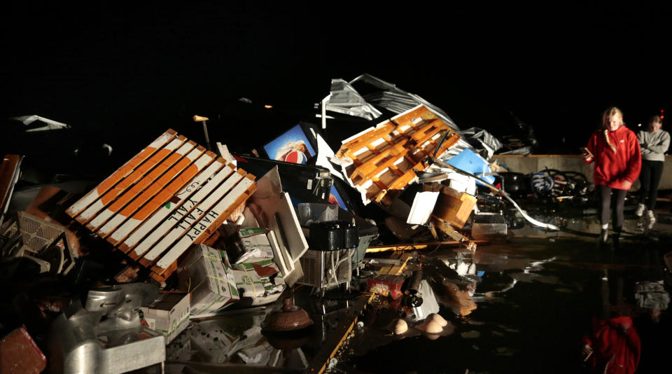 Storage unit renters look though belongings just off State Why 67 in Fredericktown, Mo. after a tornado ripped through town on Sunday, Oct. 24, 2021. (Robert Cohen/St. Louis Post-Dispatch via AP)