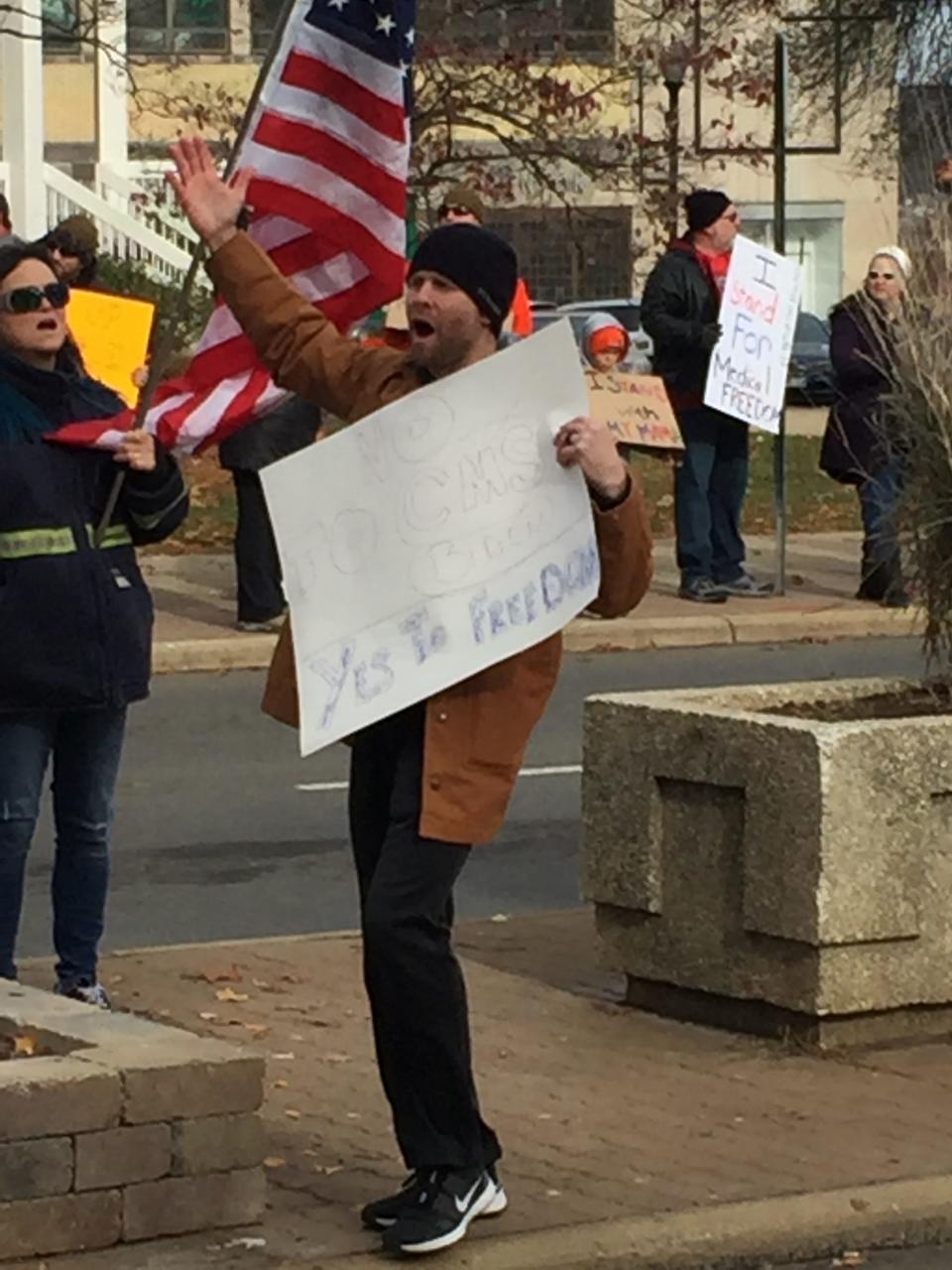 A man exhorts the crowd at Saturday's protest of vaccination mandates.