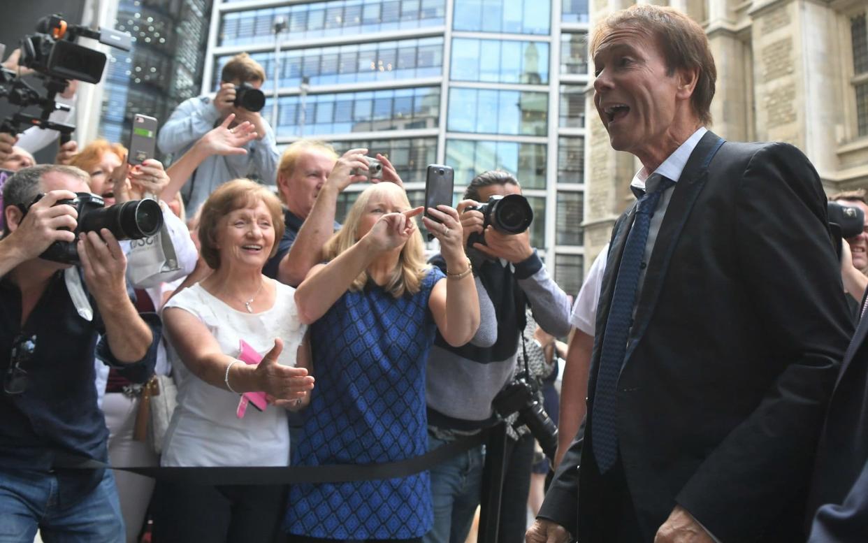 Sir Cliff arrived was greeted at court by a group of fans - PA