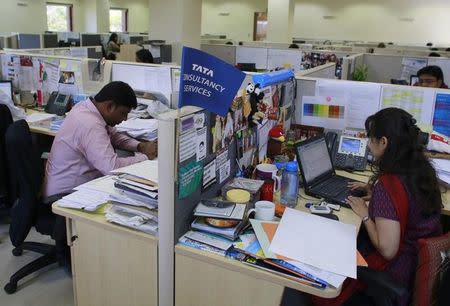 Employees of Tata Consultancy Services (TCS) work inside the company headquarters in Mumbai March 14, 2013. REUTERS/Danish Siddiqui