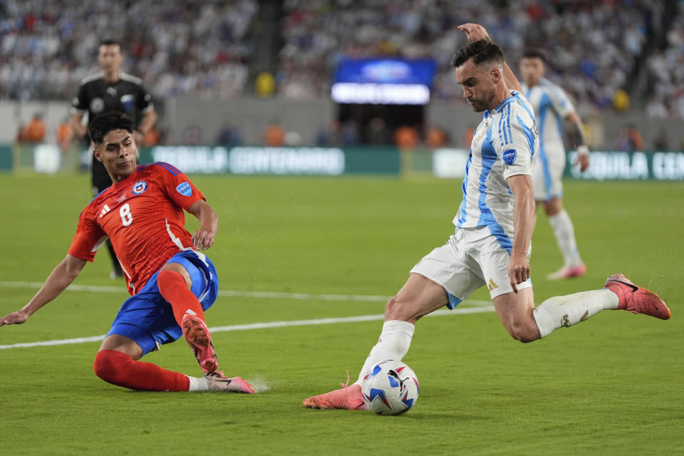 Chile's Dario Osorio attempts to block a shot from Argentina's Nicolas Tagliafico attacks during a Copa America Group A soccer match against Chile in East Rutherford, N.J., Tuesday, June 25, 2024. (AP Photo/Julia Nikhinson)