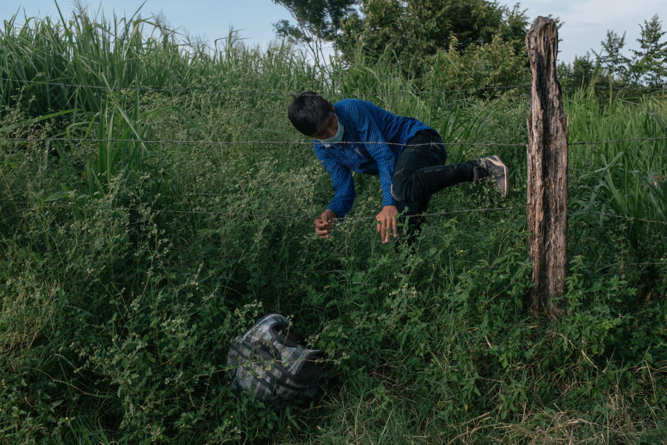 A Central American migrant goes over a fence near the port of entry at El Ceibo in Tabasco state, Mexico, on Sunday, Oct. 4, 2020. / Credit: Bloomberg