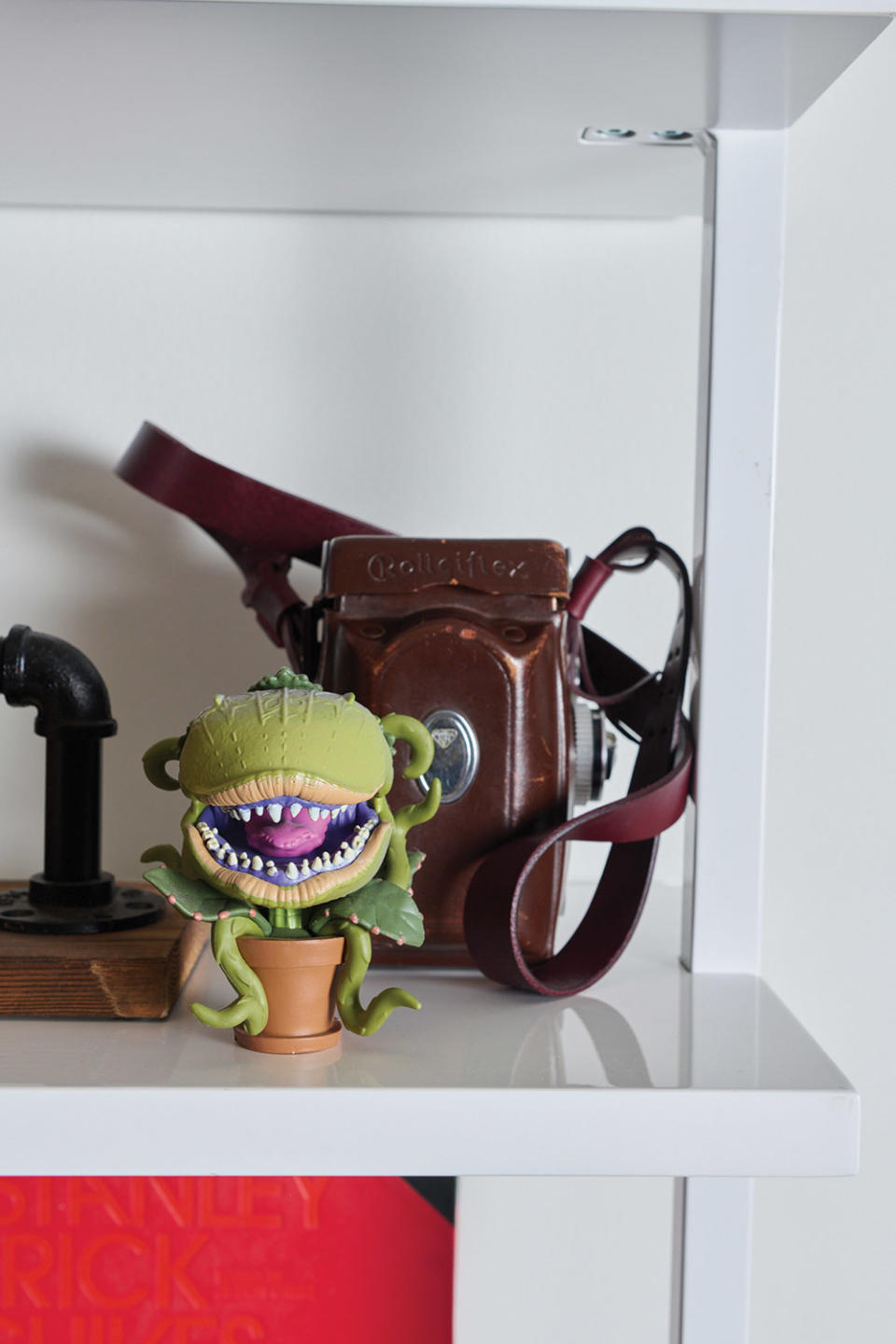 An Audrey II figurine from Little Shop of Horrors. Of Little Shop, he says, “Peak Howard Ashman, combined with peak Frank Oz, blended with Black music and the funniest ensemble casts ever — everything I need in a film and so much of what I strived to put into Haunted Mansion.”