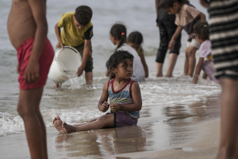 Palestinians spend the day on the beach along the Mediterranean Sea during a heatwave in Deir al Balah, Gaza Strip, Thursday, April 25, 2024. Over 80% of Gaza's population has been displaced by the ongoing war with Israel, and many have relocated to the area. Temperatures hovered near 37 degrees Celsius (100 degrees Fahrenheit). (AP Photo/Abdel Kareem Hana)