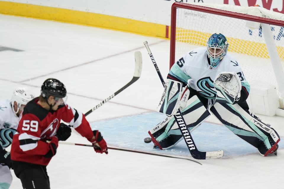 Seattle Kraken goaltender Joey Daccord (35) stops a shot by New Jersey Devils' Janne Kuokkanen (59) during the third period of an NHL hockey game Tuesday, Oct. 19, 2021, in Newark, N.J. The Devils won 4-2. (AP Photo/Frank Franklin II)