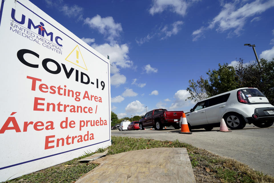 Drivers wait in line at a United Memorial Medical Center COVID-19 testing site Thursday, Nov. 19, 2020, in Houston. Texas is rushing thousands of additional medical staff to overworked hospitals as the number of hospitalized COVID-19 patients increases. (AP Photo/David J. Phillip)