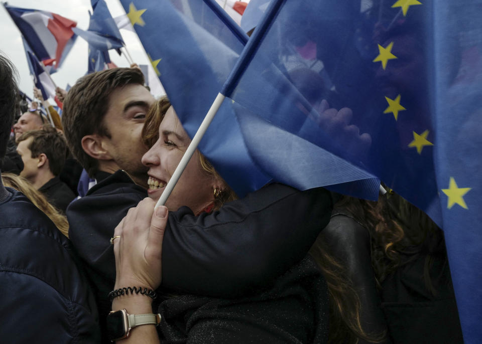 Supporters of French President Emmanuel Macron celebrate in Paris, France, Sunday, April 24, 2022. Polling agencies projected that French President Emmanuel Macron comfortably won reelection Sunday in the presidential runoff, offering French voters and the European Union the reassurance of leadership stability in the bloc's only nuclear-armed power as the continent grapples with Russia's invasion of Ukraine. (AP Photo/Rafael Yaghobzadeh)