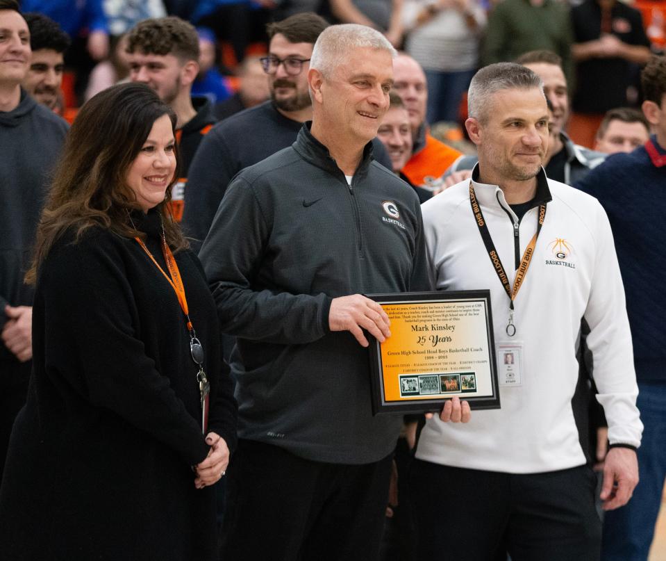 Mark Kinsley (center) is honored before Friday's game against Lake for his 25th year as head coach of Green High School boys basketball. At left is Green High School principal Cindy Brown and at right is Green athletic director Erich Muzi. Friday, Jan. 27, 2023.
