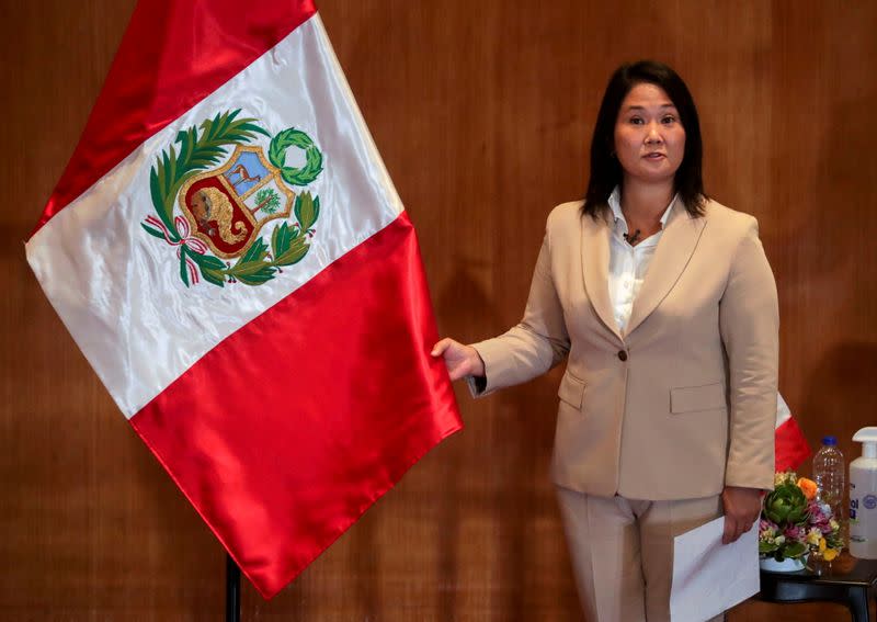 FILE PHOTO: Peruvian presidential candidates Keiko Fujimori, who will face Pedro Castillo in a run-off vote on June 6, holds Peru's national flag, in Lima