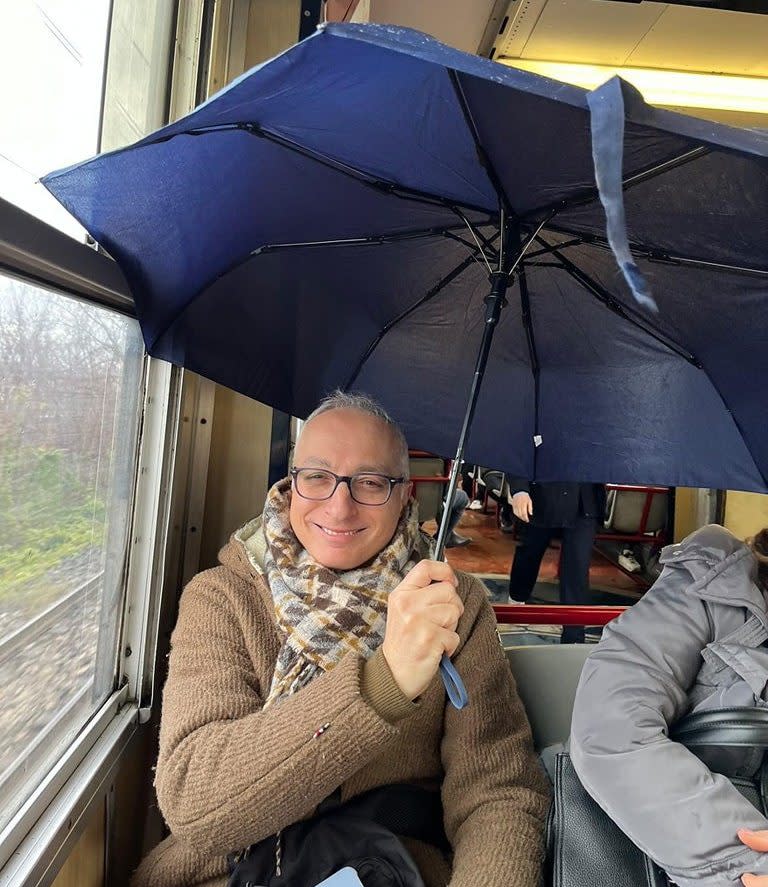 A passenger stays dry as the train creaks its way from Naples around the Bay of Naples towards the Amalfi Coast