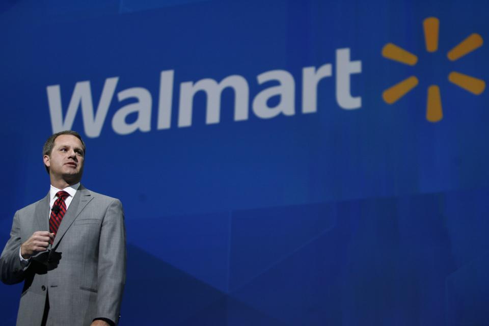 CORRECTS SPELLING OF LAST NAME TO MCMILLON INSTEAD OF MCMILLAN - President and CEO, Wal-mart International Doug McMillon addresses the crowd on the company 's 2012 worldwide sales during the Wal-mart shareholders meeting in Fayetteville, Ark., Friday, June 7, 2013. (AP Photo/Gareth Patterson)