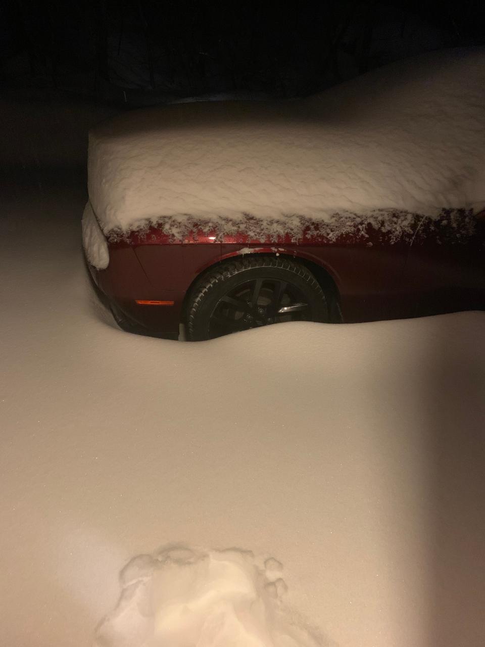 car in vermont covered in snow
