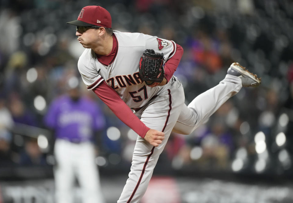 Arizona Diamondbacks relief pitcher Taylor Widener works against the Colorado Rockies in the seventh inning of a baseball game Saturday, Sept. 10, 2022, in Denver. (AP Photo/David Zalubowski)