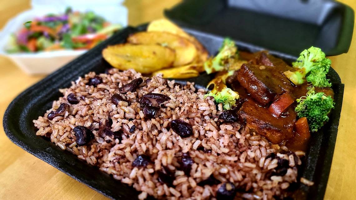 Brown Stew Vege Chicken with rice and beans served with a vegetable salad and plantains at Roots Plant Based Cafe in Byron.