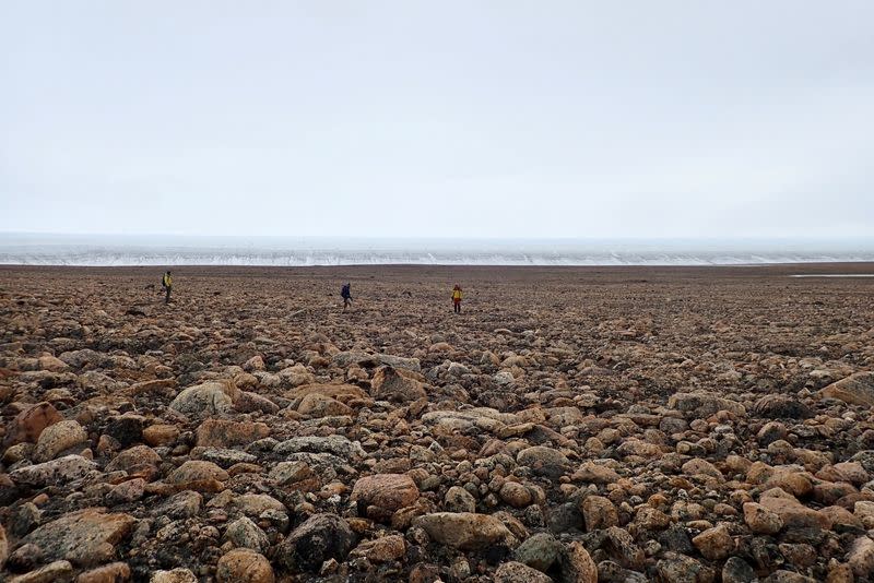 Scientists perform research field work at the edge of the Greenland Ice Sheet