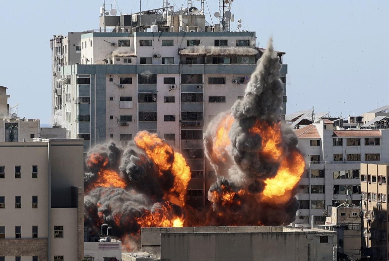 A ball of fire erupts from a building housing various international media, including The Associated Press, after an Israeli airstrike on Saturday, May 15, 2021, in Gaza City.