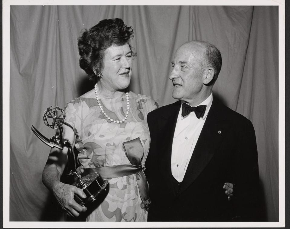 Julia Child (left) and Paul Child (right) pose with an Emmy trophy