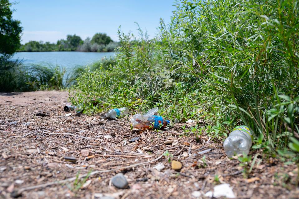 Trash litters the shoreline of Runyon Lake. A cleanup project is forcing the closure of the lake from July 1-8.