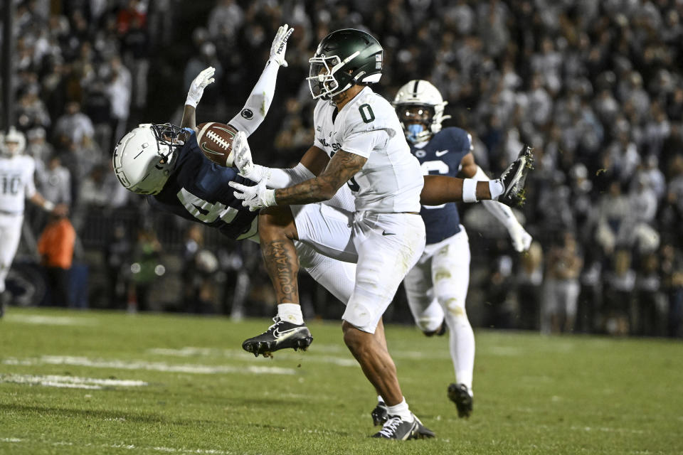 Penn State cornerback Kalen King (4) breaks up a pass intended for Michigan State wide receiver Keon Coleman (0) during the first half of an NCAA college football game, Saturday, Nov. 26, 2022, in State College, Pa. (AP Photo/Barry Reeger)