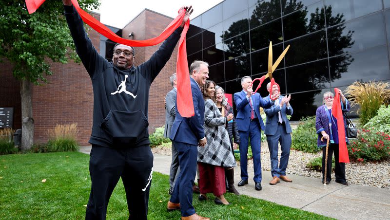 Adolphus Nickelberry holds a portion of the cut ribbon as he and others attend a celebration at the University of Utah Health’s new Rose Park Population Health Center on Thursday.