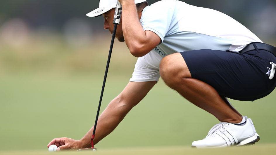 Xander Schauffele lining up a putt at Pinehurst