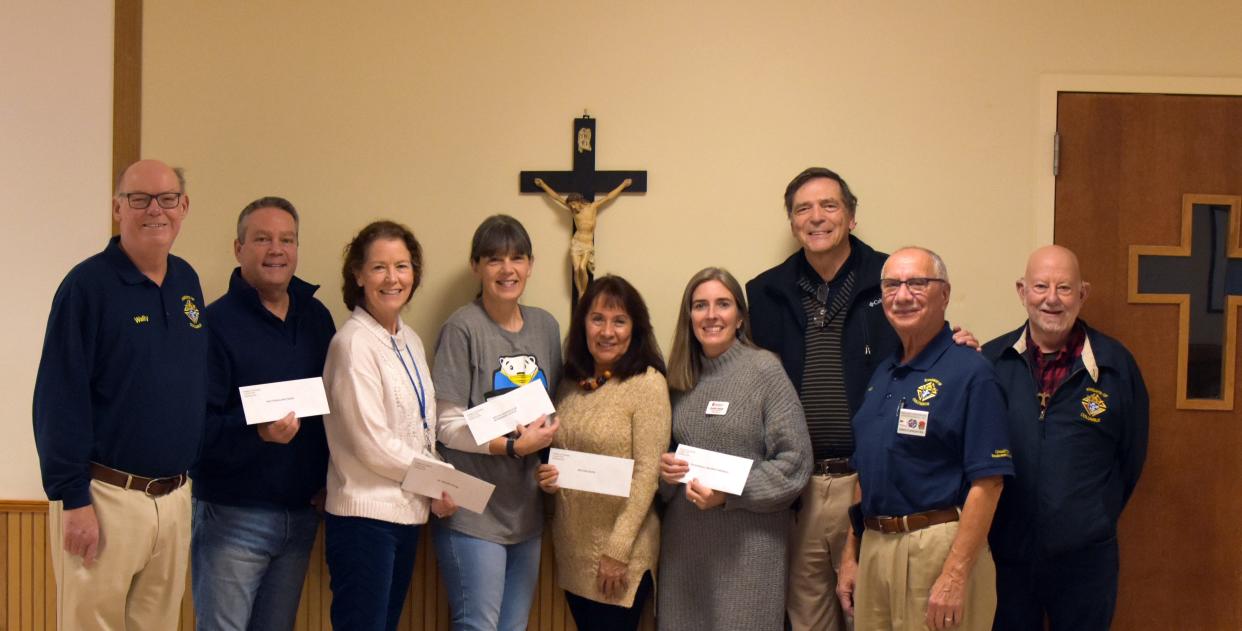 From left to right are Wally Walsworth (outgoing Operation LAMB director), Allen Combs of Vocational Solutions, Caroline Long of St. Gerard House, Natalie Stiles of Special Olympics, Martha Castro of Helping Hand, Jennifer Shelton of Exceptional Children's Program, David Chapman of Mountain Bowlers, Arnie Spadafora (the new Operation LAMB director) and Gene Ray MaGruder (Grand Knight).