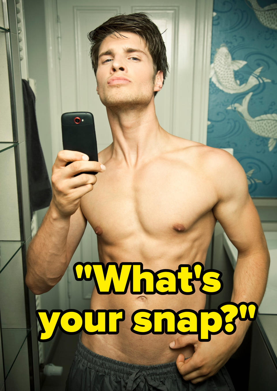 A shirtless man taking a selfie