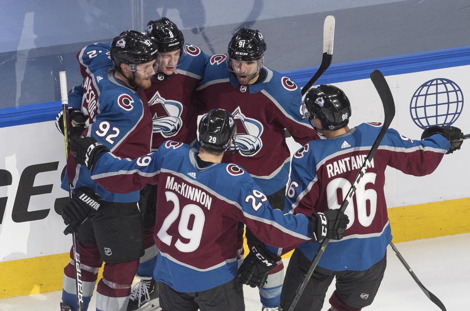 Colorado Avalanche players celebrate a goal against the Arizona Coyotes during the third period of a first-round NHL Stanley Cup playoff hockey game in Edmonton, Ontario, on Wednesday, Aug. 12, 2020. (Jason Franson/The Canadian Press via AP)