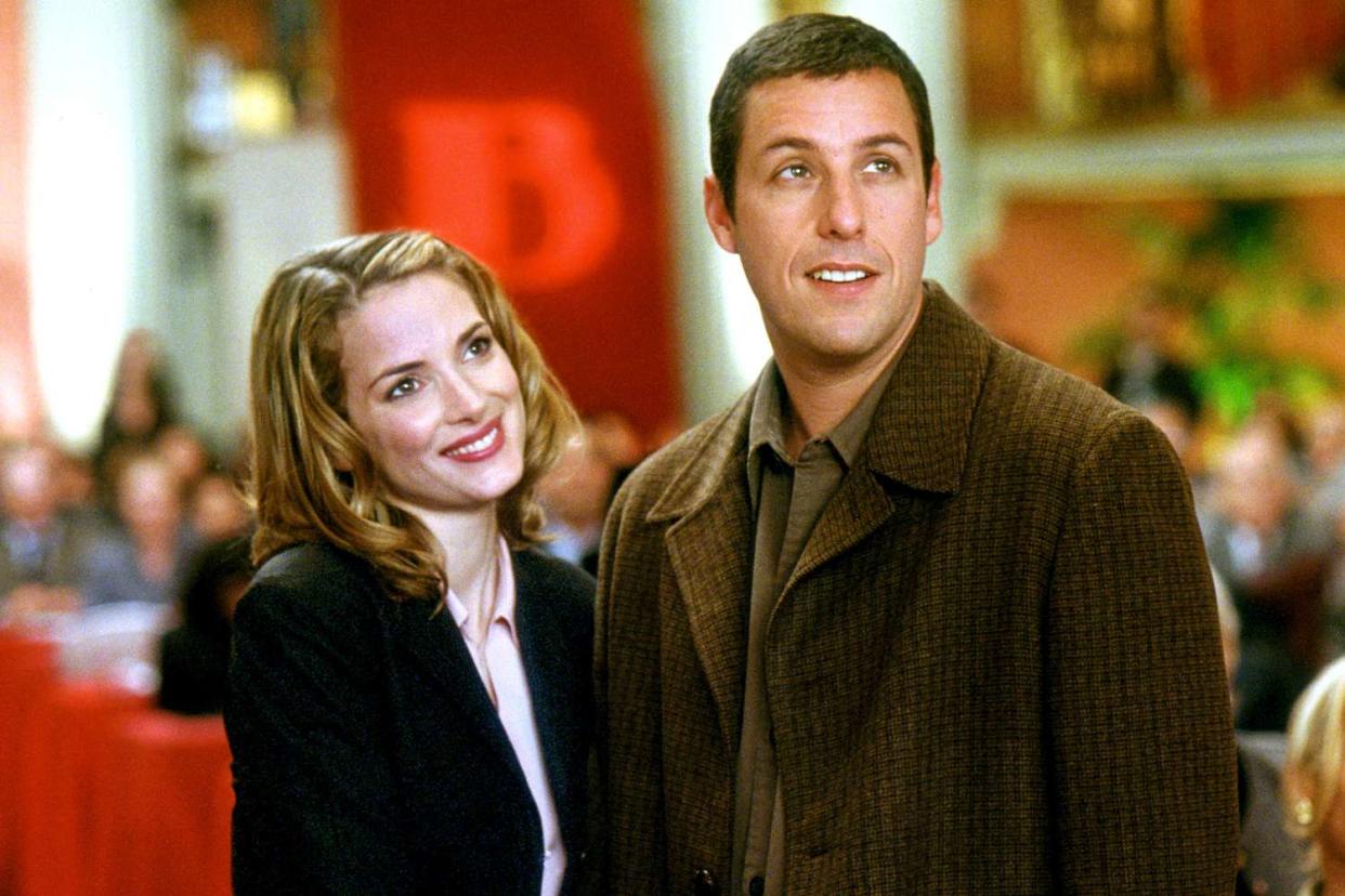 Winona Ryder in a black jacket and Adam Sandler in a brown coat in "Mr. Deeds."