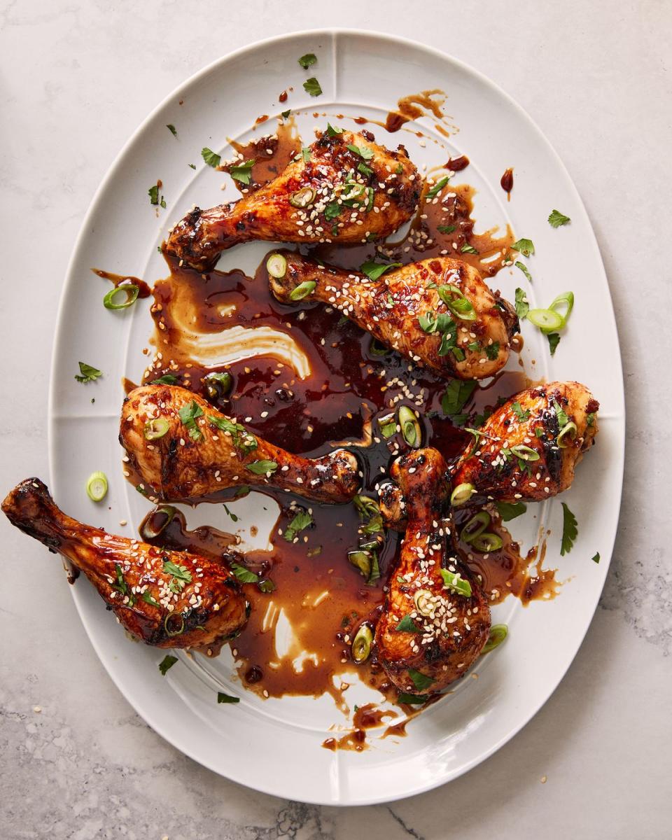 air fryer drumsticks coated in a soy, coca cola sauce topped with sesame seeds