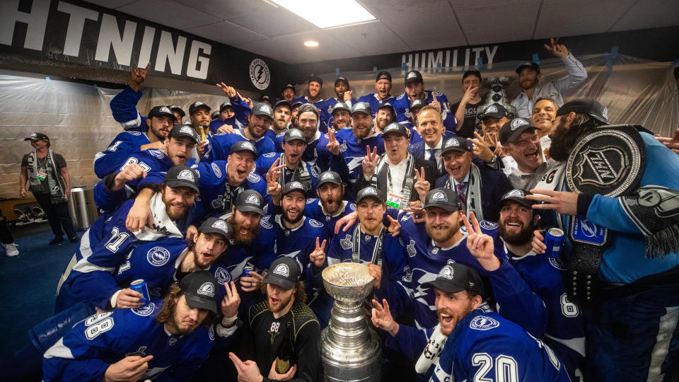 TAMPA, FL - JULY 7: The Tampa Bay Lightning celebrates in the locker room with the Stanley Cup after the Tampa Bay Lightning defeated the Montreal Canadiens in Game Five to win the best of seven game series 4-1 during the Stanley Cup Final of the 2021 Stanley Cup Playoffs at Amalie Arena on July 7, 2021 in Tampa, Florida. (Photo by Scott Audette/NHLI via Getty Images)