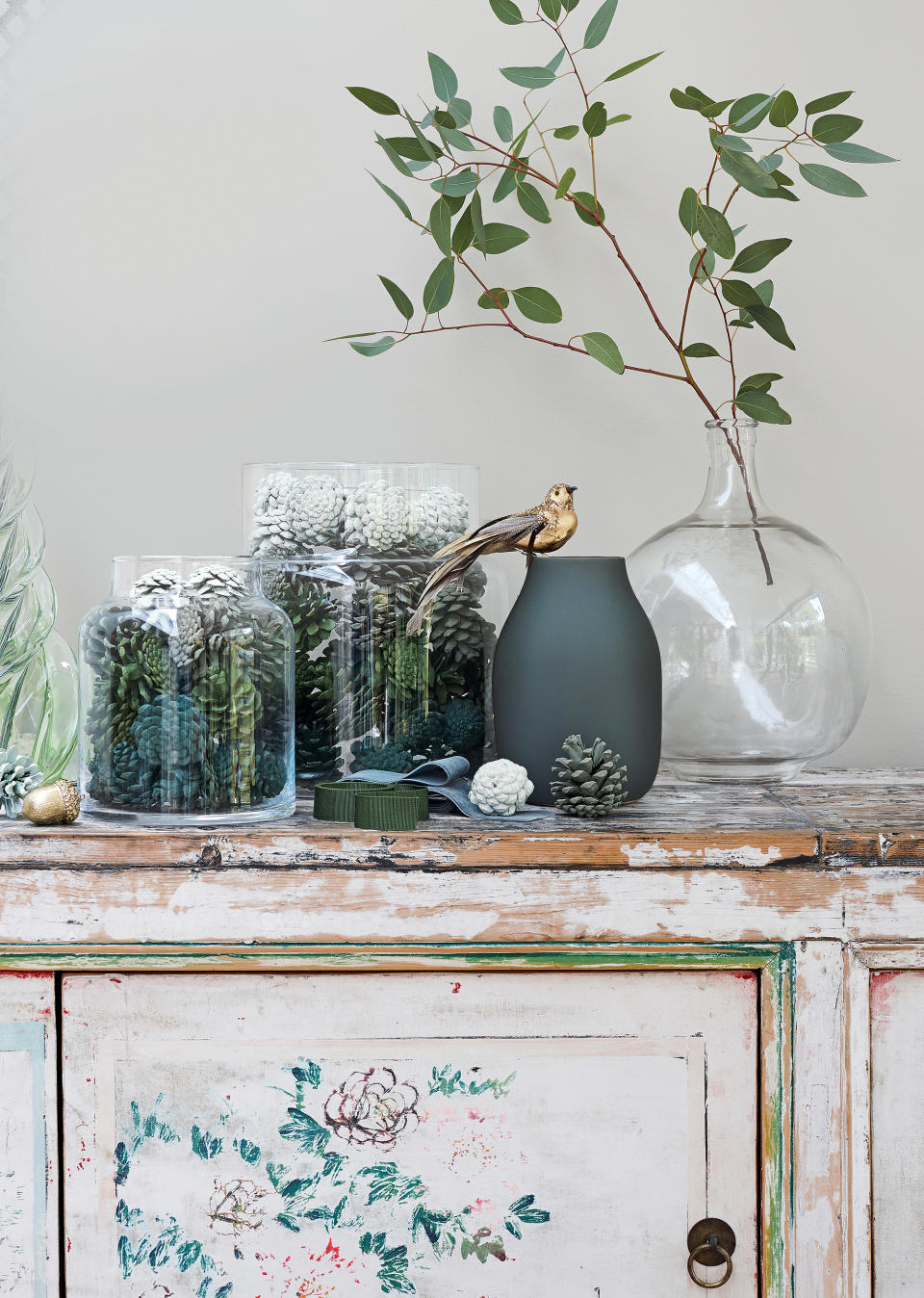 sprayed pine cones displayed in vases