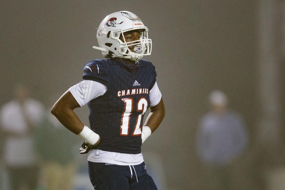 Chaminade-Madonna's Zaquan Patterson (12) walks off the field to meet with his team during a timeout. Chaminade-Madonna shutout Berkeley Prep 21-0 to claim the 3A State Championship title at Gene Cox Stadium on Friday, Dec. 10, 2021.