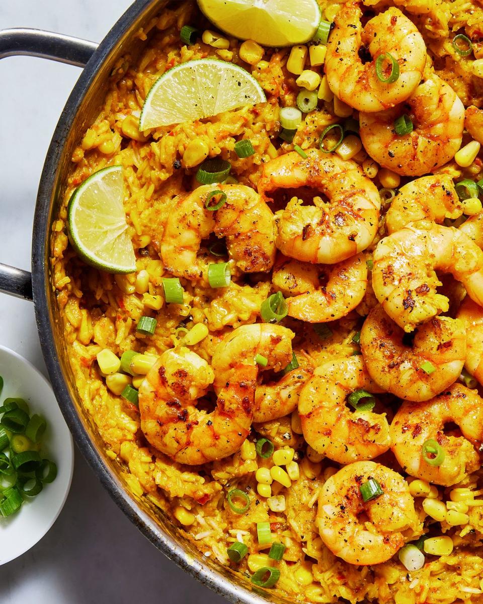 rice skillet topped with shrimp and sweet corn