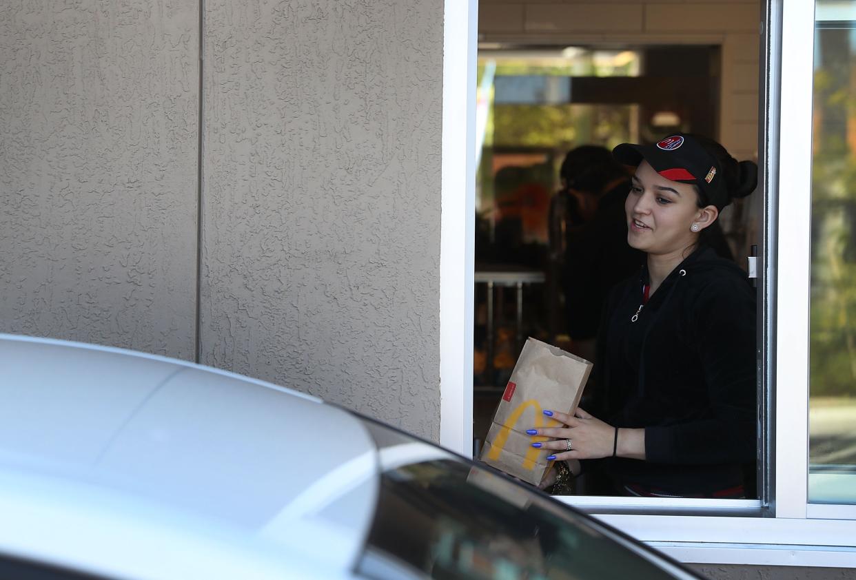 McDonald’s crew member Tatiana Cordoso works the drive thru window as the McDonald’s restaurant on April 25, 2017 in Miami, Florida. (Photo by Joe Raedle/Getty Images)