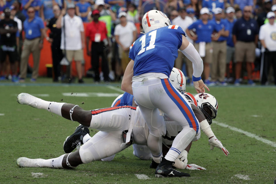 Florida quarterback Kyle Trask (11) is injured as he is hit by Auburn defensive end Marlon Davidson during the first half of an NCAA college football game, Saturday, Oct. 5, 2019, in Gainesville, Fla. (AP Photo/John Raoux)