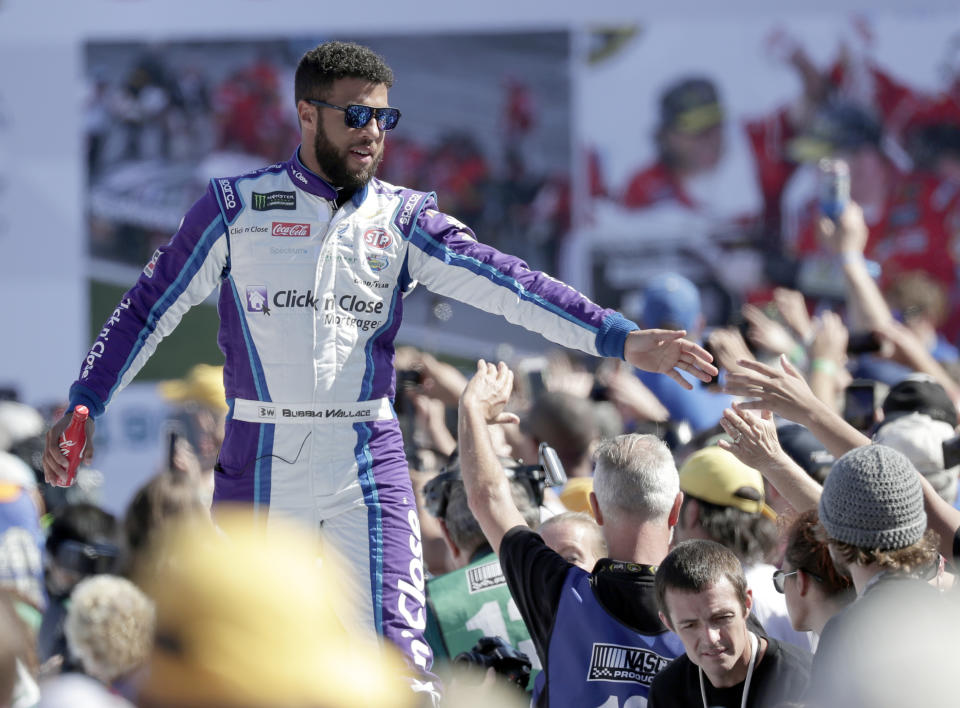 Darrell Wallace Jr. greets fans as he is introduced before the NASCAR Daytona 500 Cup series auto race at Daytona International Speedway in Daytona Beach, Fla., Sunday, Feb. 18, 2018. (AP Photo/John Raoux)