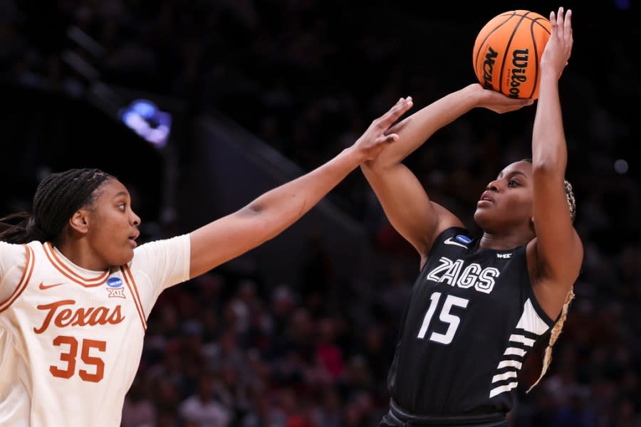 Gonzaga forward Yvonne Ejim (15) shoots as Texas forward Madison Booker (35) defends during the first half of a Sweet 16 college basketball game in the women’s NCAA Tournament, Friday, March 29, 2024, in Portland, Ore. (AP Photo/Howard Lao)