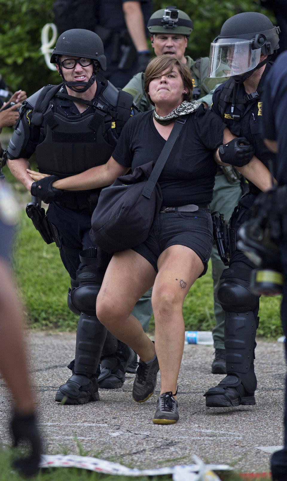 Police arrest protesters after dispersing crowds in a residential neighborhood in Baton Rouge, La. on Sunday, July 10, 2016. After an organized protest in downtown Baton Rouge protesters wondered into residential neighborhoods and toward a major highway that caused the police to respond by arresting protesters that refused to disperse. (AP Photo/Max Becherer)