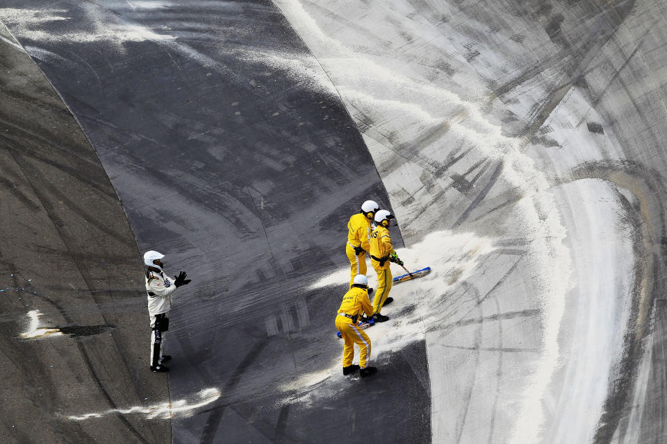 BRISTOL, TN - MARCH 18: Safety crew members clean up after an on track incident during the NASCAR Sprint Cup Series Food City 500 at Bristol Motor Speedway on March 18, 2012 in Bristol, Tennessee. (Photo by Chris Trotman/Getty Images)