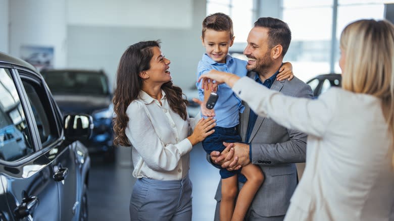 family buying car at dealership