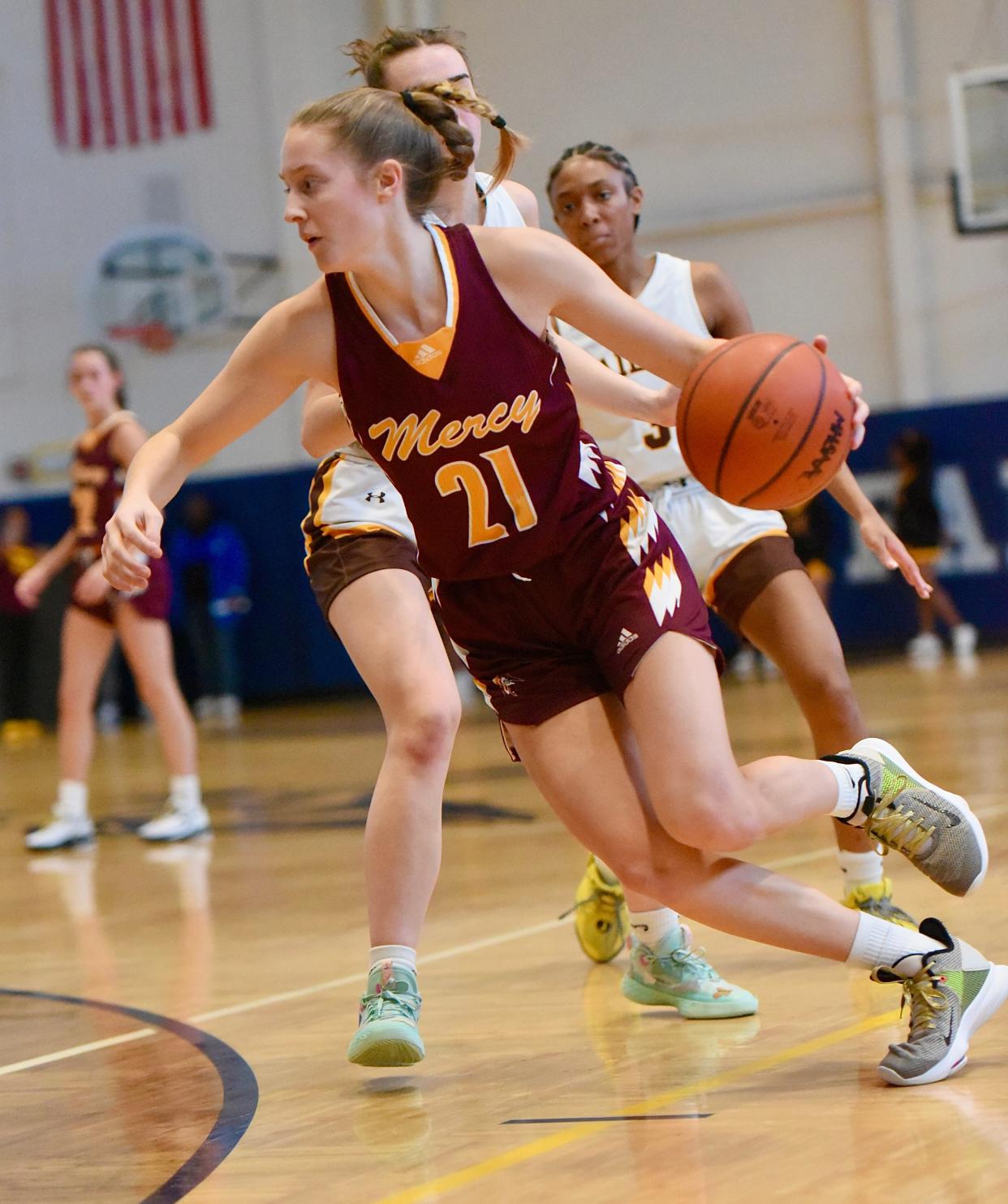 Farmington Hills Mercy's Aizlyn Albanese attacks the basket during the Division 1 girls basketball district championship Saturday, March 5, 2023, at Farmington.