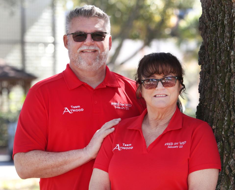 Ken and Kat Atwood, wearing Team Atwood shirts to promote World Encephalitis Day on Thursday, are pictured outside of Port Orange City Hall. They are working to raise awareness of the disease that has changed their lives.