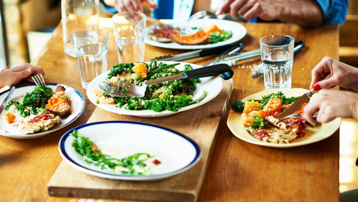  A family eating lunch from plates. 