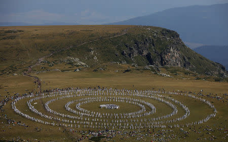 Followers of the Universal White Brotherhood, an esoteric society that combines Christianity and Indian mysticism set up by Bulgarian Peter Deunov in the 1920s, perform a dance-like ritual called "paneurhythmy" in Rila Mountain, Bulgaria, August 19, 2017. REUTERS/Stoyan Nenov