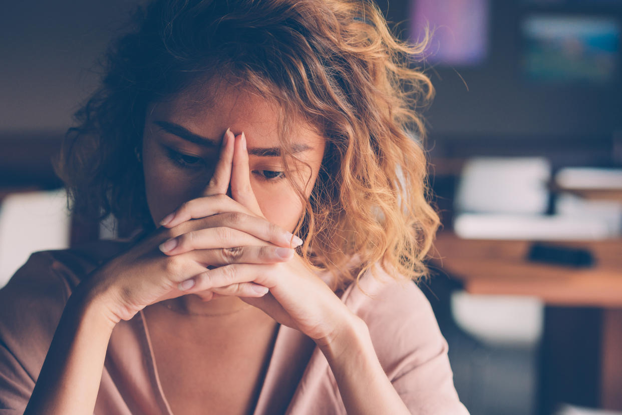 Woman looking stressed, suffering from burnout. (Getty Images)