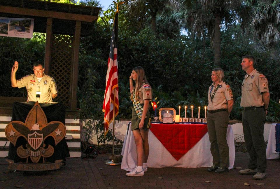 Mia Stahl, the first female Eagle Scout from Martin County, is lead through the Presentation of the Eagle Rank by her former Scoutmaster Mike Kelly at a ceremony on Dec. 10, 2023 at the Jupiter Inlet Lighthouse Outstanding Natural Area.