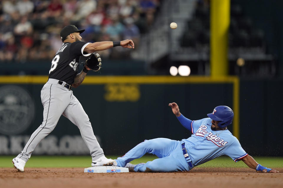 Chicago White Sox second baseman Leury Garcia (28) throws to first base to get out Texas Rangers' Corey Seager for a double play over Rangers' Marcus Semien, right, during the first inning of a baseball game in Arlington, Texas, Sunday, Aug. 7, 2022. (AP Photo/LM Otero)