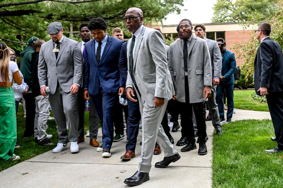 Michigan State's acting head coach Harlon Barnett, center, and the football team walk to Spartan Stadium from the Kellogg Center before the game against Washington on Saturday, Sept. 16, 2023, in East Lansing.